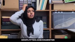 A police officer disciplines a curvy Muslim woman on a desk