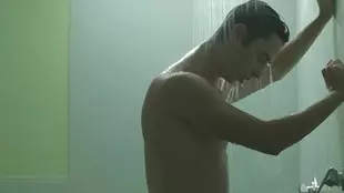 A beautiful young woman indulges in a playful shower experience with a climax