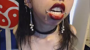 Goth girl drools on red hot lipstick and gags on B in this playful video