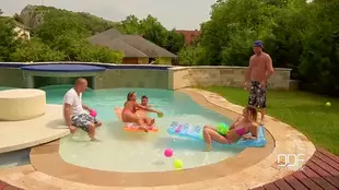 Two blonde European women enjoy double penetration in a pool