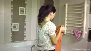 A brunette beauty indulges in self-pleasure in the bathroom during her bath