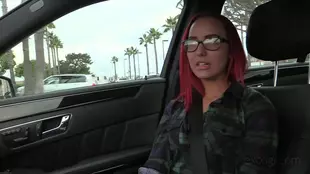 A fiery redhead indulges in intense car passion while wearing her spectacles