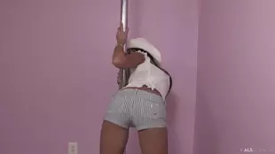 A slender woman in high heels indulges in self-pleasure with sex toys and a stripper pole